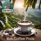 A hot cup of Bali Coffee with single-serve pods, Bali scenery, in the background.