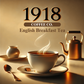 Minimalist image of 1918 Coffee Co.'s English Breakfast tea. It features a warm-toned background of gold and amber, with a gently steaming teacup on a simple table. Subtle elements like a kettle, plate, and spoon create a cozy breakfast setting, focusing solely on the tea in a serene morning atmosphere