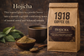 1918 Coffee Co.’s Hojicha roasted green tea powder in a kraft pouch beside a warm ceramic cup and wooden bowls of powder and tea leaves.