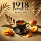 Minimalist image of 1918 Coffee Co.'s Mango Treat tea. The design features a warm, tropical background with golden yellows and soft oranges. Scattered mango slices and fresh tea leaves surround a steaming teacup, highlighting the tropical and refreshing essence of the tea without any text or typography